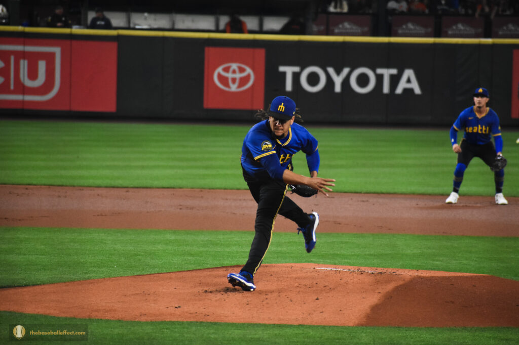Luis Castillo throws a pitch to Lamonte Wade Jr.