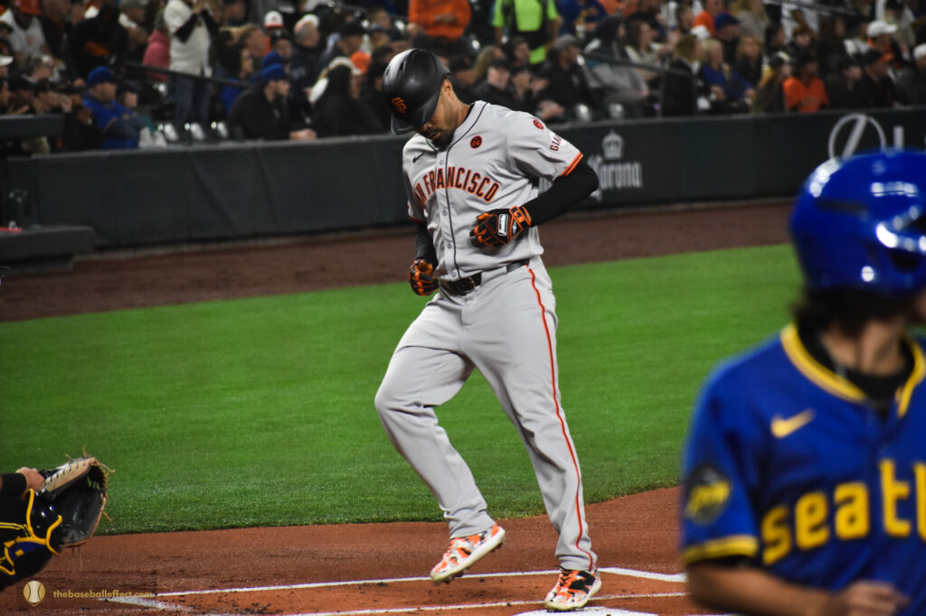Lamont Wade Jr. touches home plate after hitting a homerun